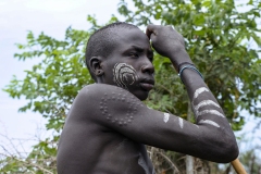 Young Mursi Warrior with Body Scarnification Omo Valley Turmi Ethiopia