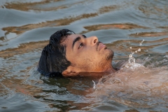 Man Swimming in Gange River Varanasi Uttar Pradesh India