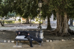 Man Sleeping on Bench in Villa Garibaldi's Gardens in Marina Square Palermo Italy